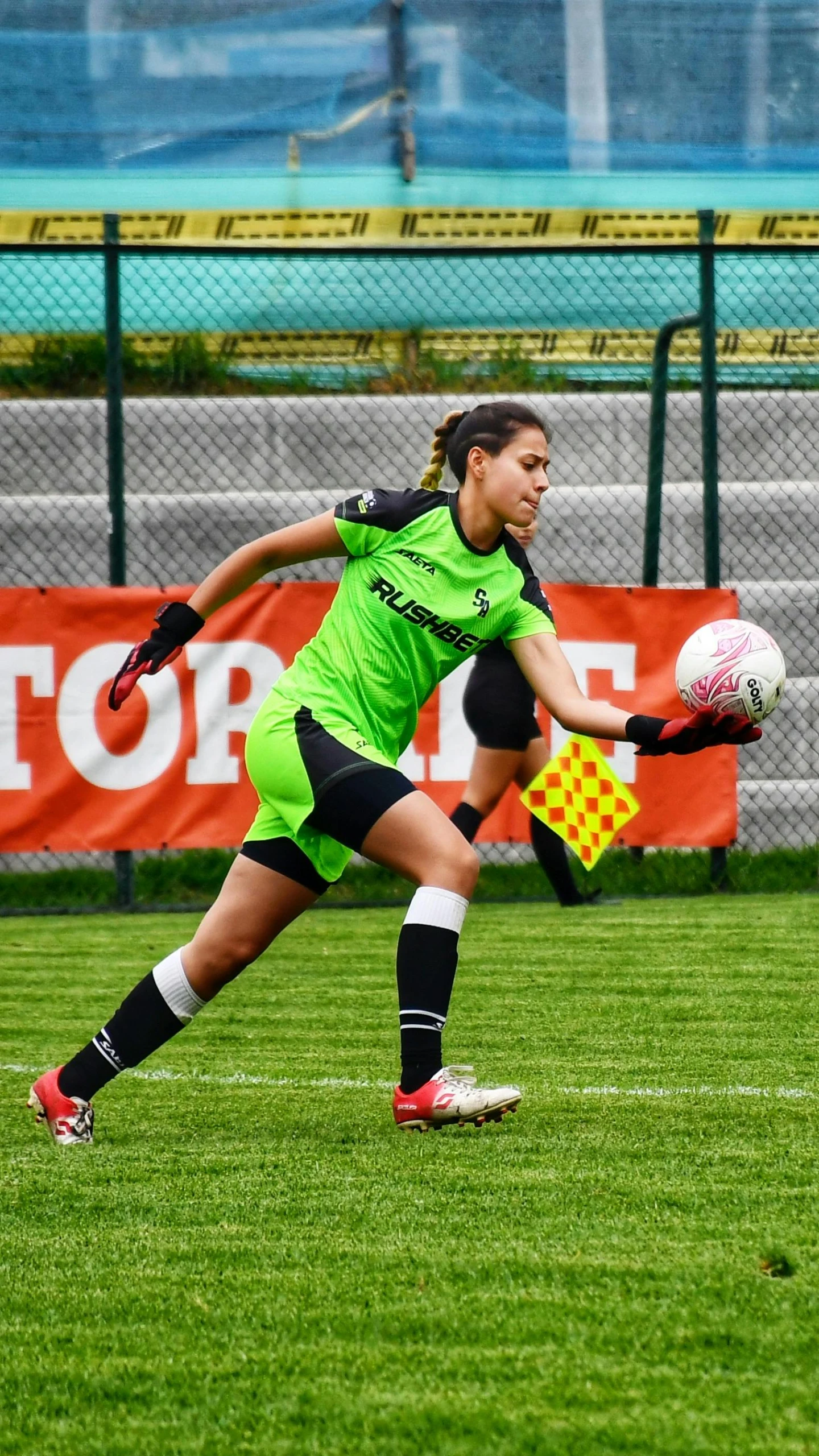 a young lady prepares to kick the soccer ball