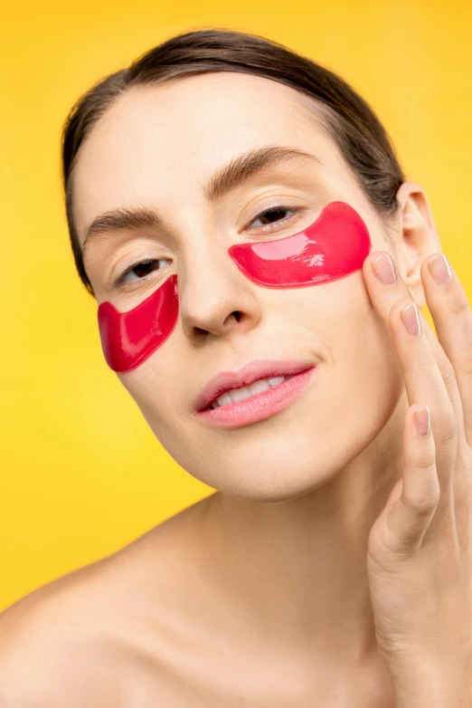 a beautiful woman with red paint on her face