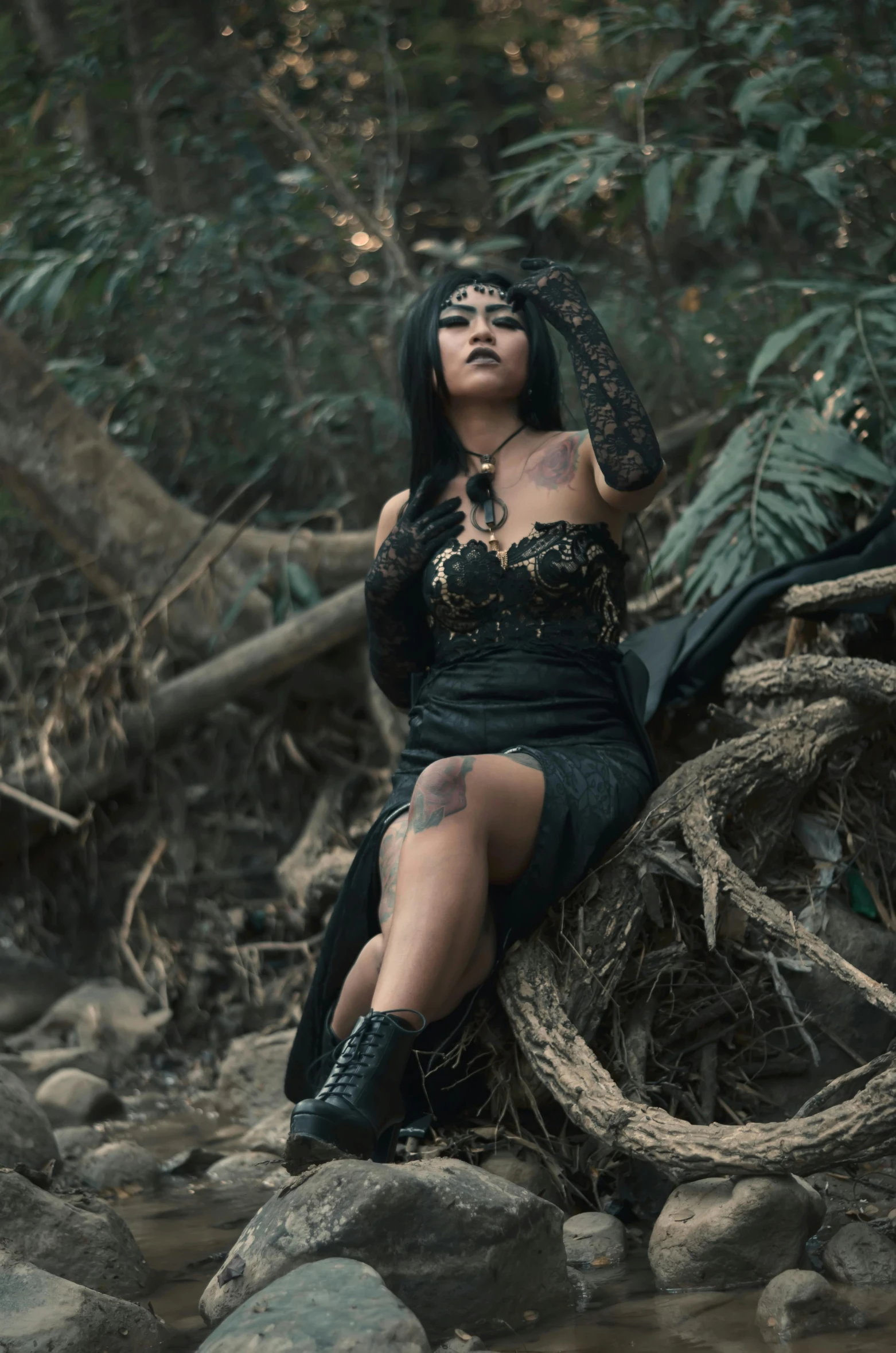 a lady dressed in black sitting on rocks next to water