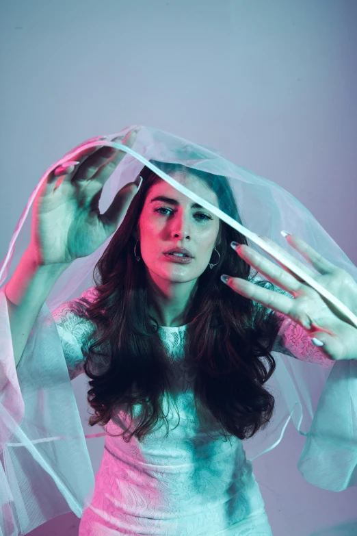 a woman is posing in front of a light up umbrella