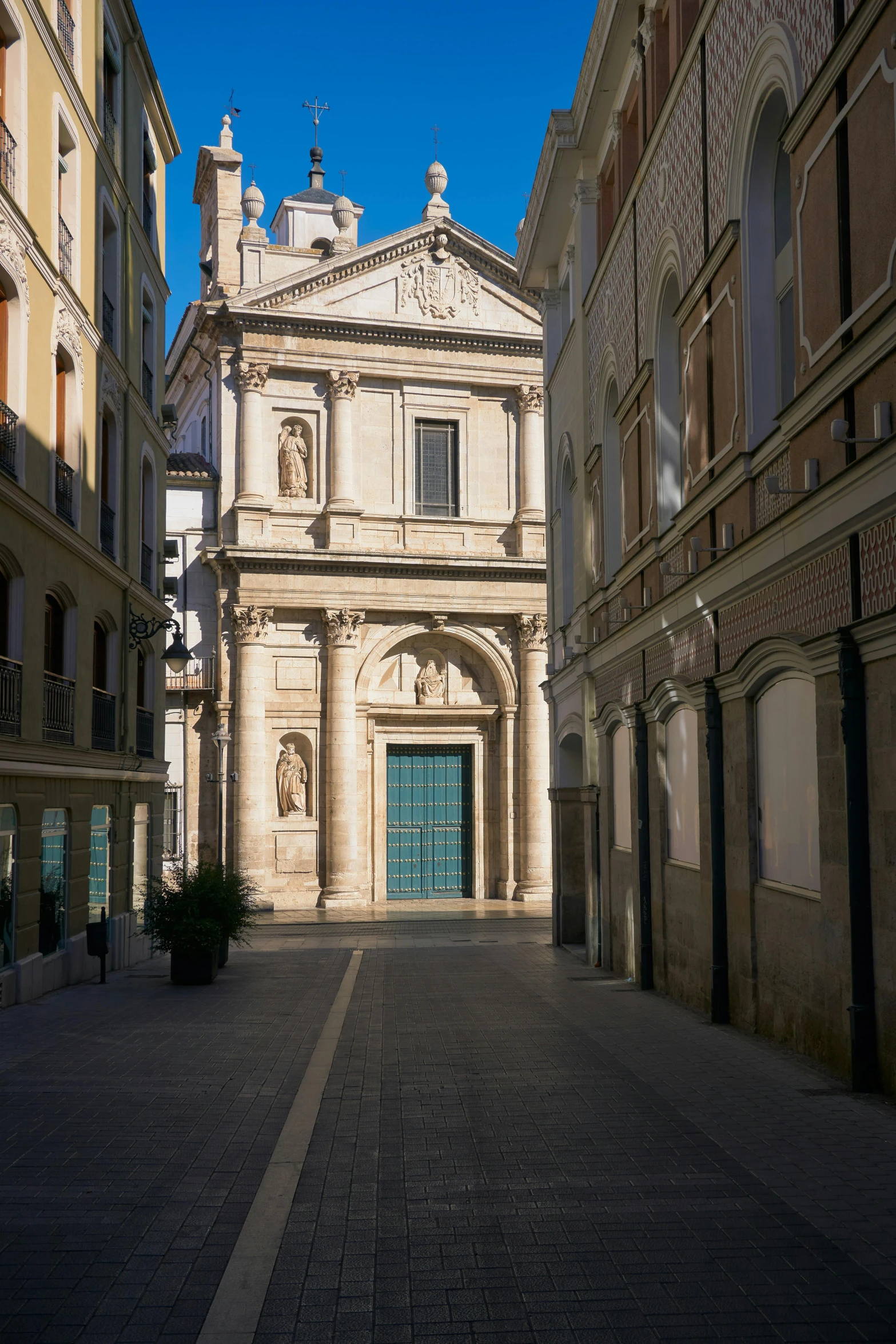 some brown buildings are standing on a street