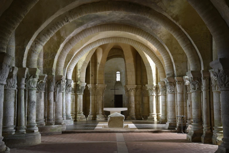 an empty cathedral with arches and a fountain