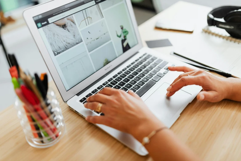 a woman is working on her laptop and writing