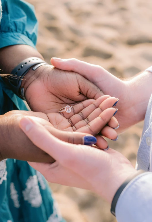 two women are holding out their hands together