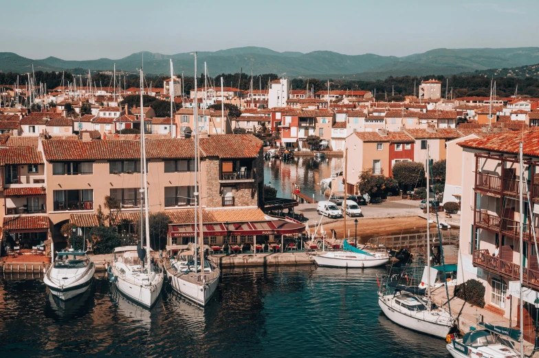 a couple of boats floating in a body of water near many buildings