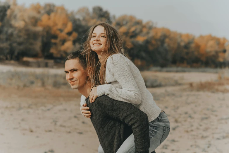 a woman giving her man the lift on his shoulders