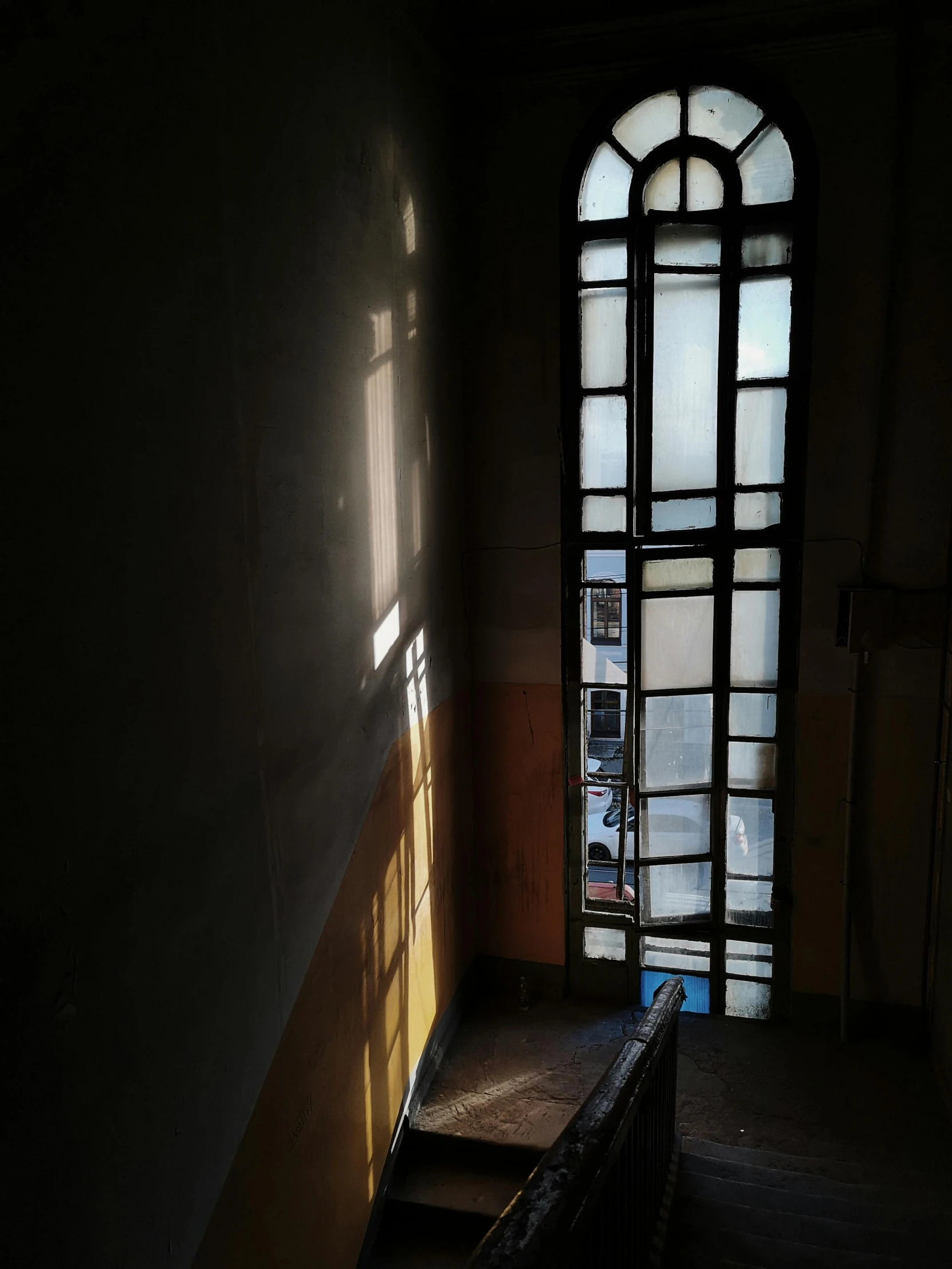 a long window in the corner of a dark room