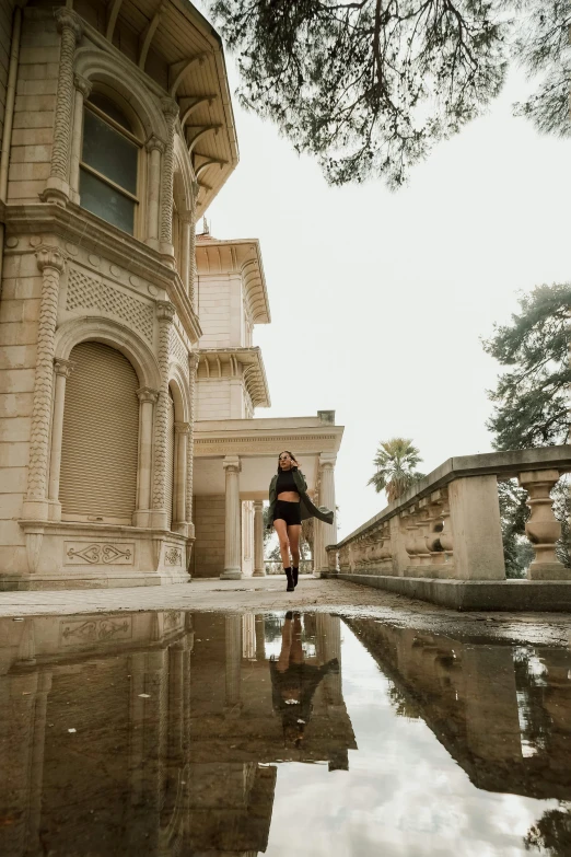 a person stands outside of a large house