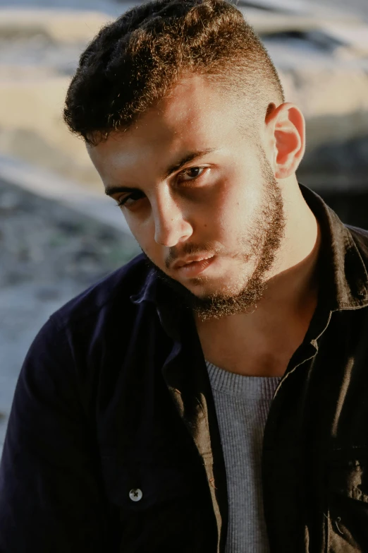 a man with short hair, looking ahead