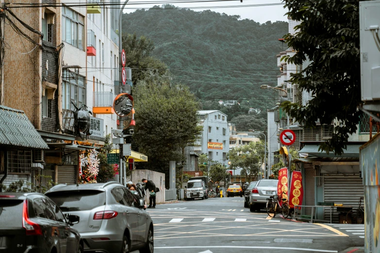 cars parked along the side of a narrow street