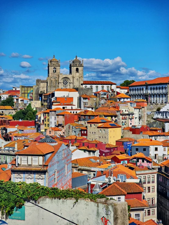 the roofs of several buildings with blue sky in the background