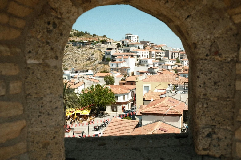 view through a window on a small village with red roofs