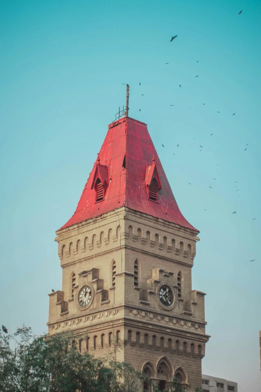 a tall building with a clock and red roof