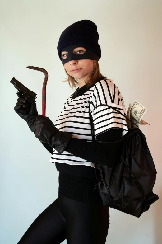 a girl wearing gloves and holding an umbrella