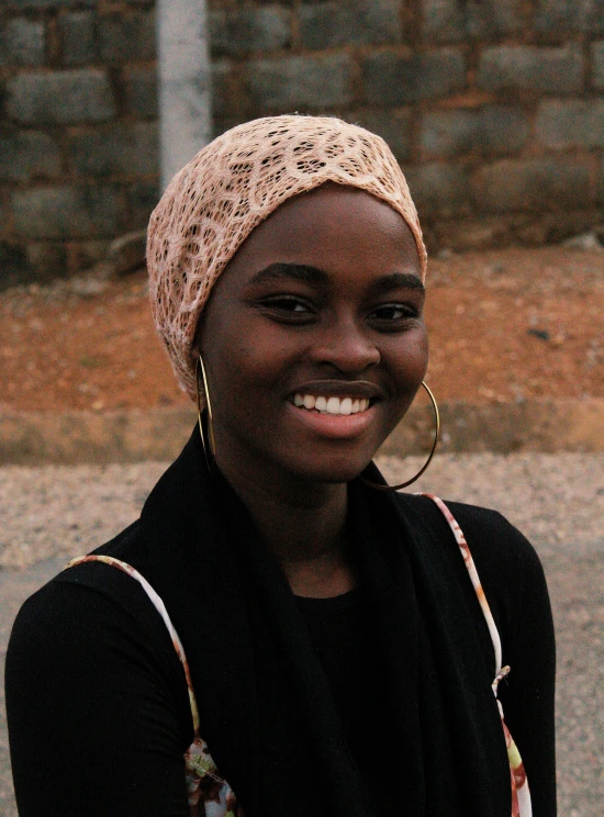 a young lady smiling in the middle of a street