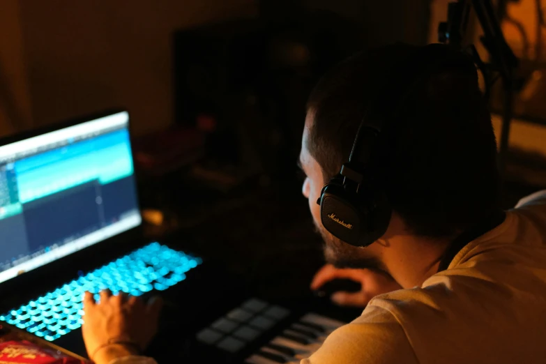 a man in headphones is using a computer