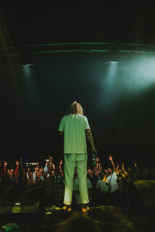 a person wearing a green shirt on stage