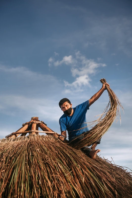 three men sitting on top of a straw roof