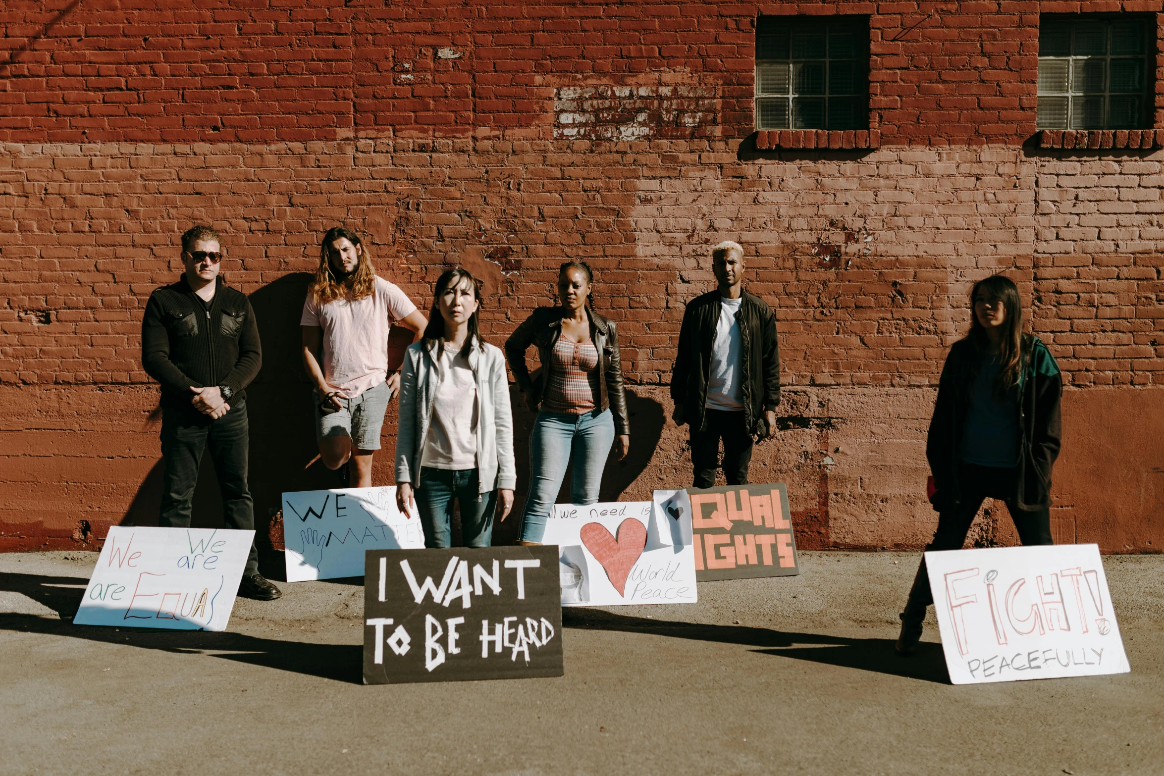 several people standing outside and one with signs