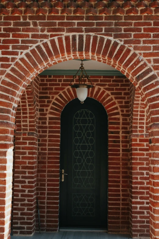an arched entryway between two brick buildings