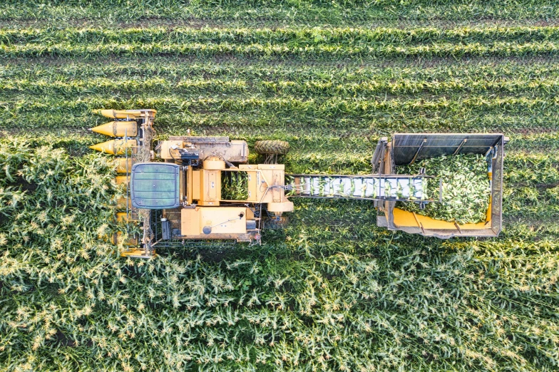 a tractor is in the middle of some green grass