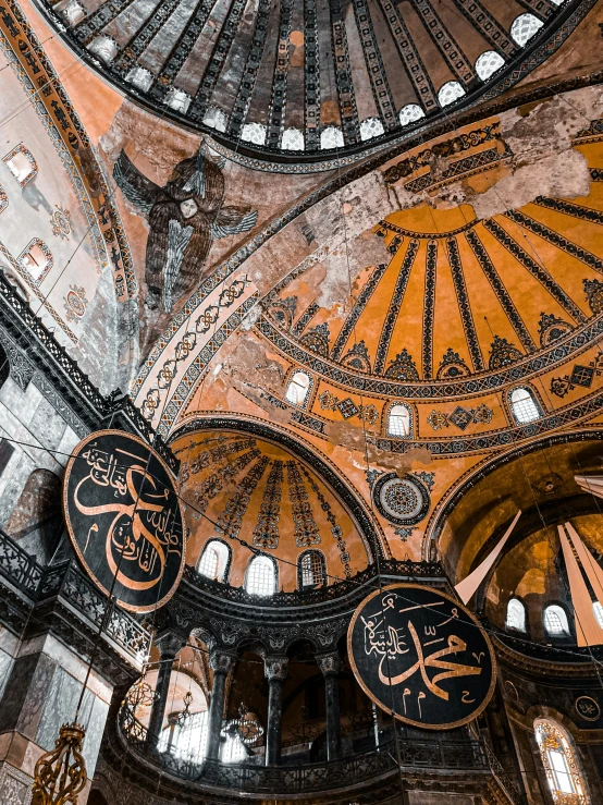 an elaborate dome with round chandeliers and ornate details