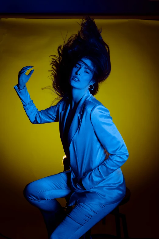 a woman in blue with hair blowing
