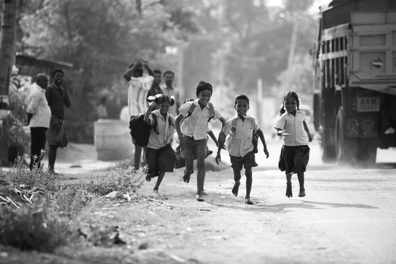 a group of young children running towards the camera