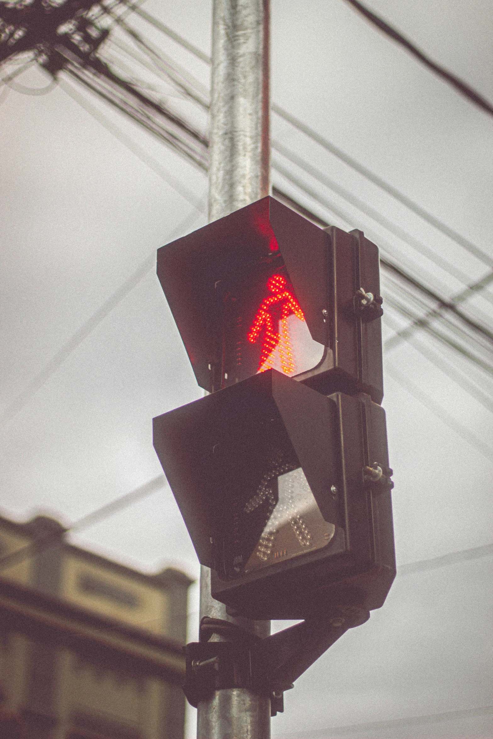 a stop light that is hanging from a pole