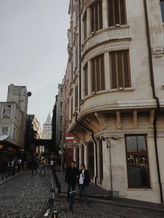 two men walking down an old brick street