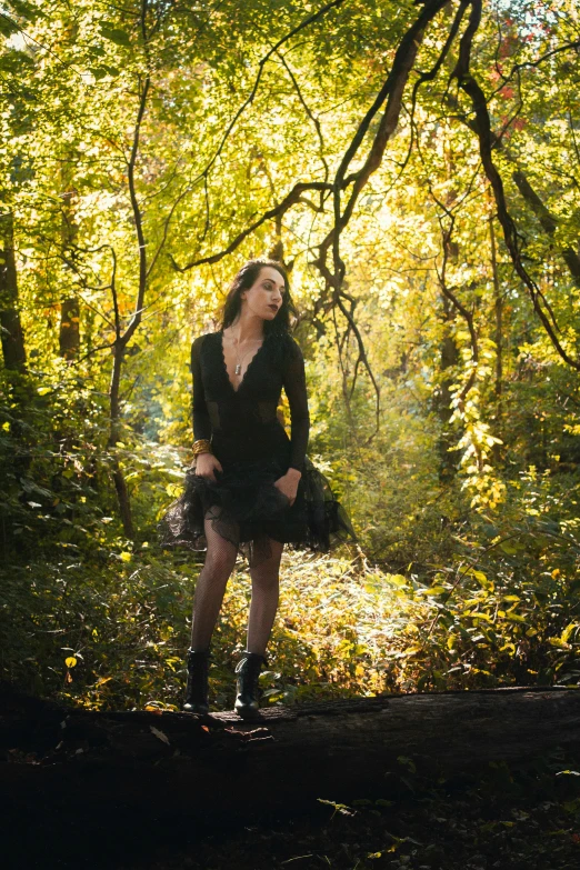 a beautiful woman in the woods wearing high heeled boots