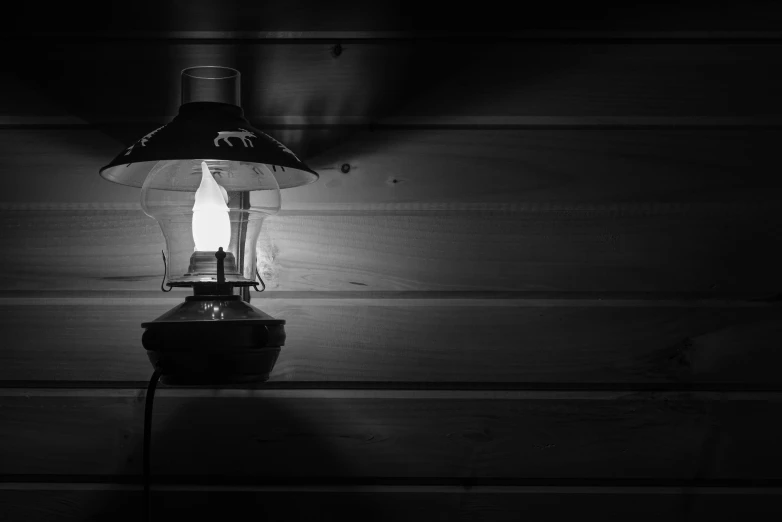 black and white pograph of a lamp on a wall