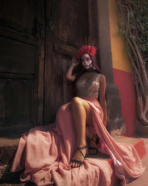 a woman sitting on steps, dressed in pink