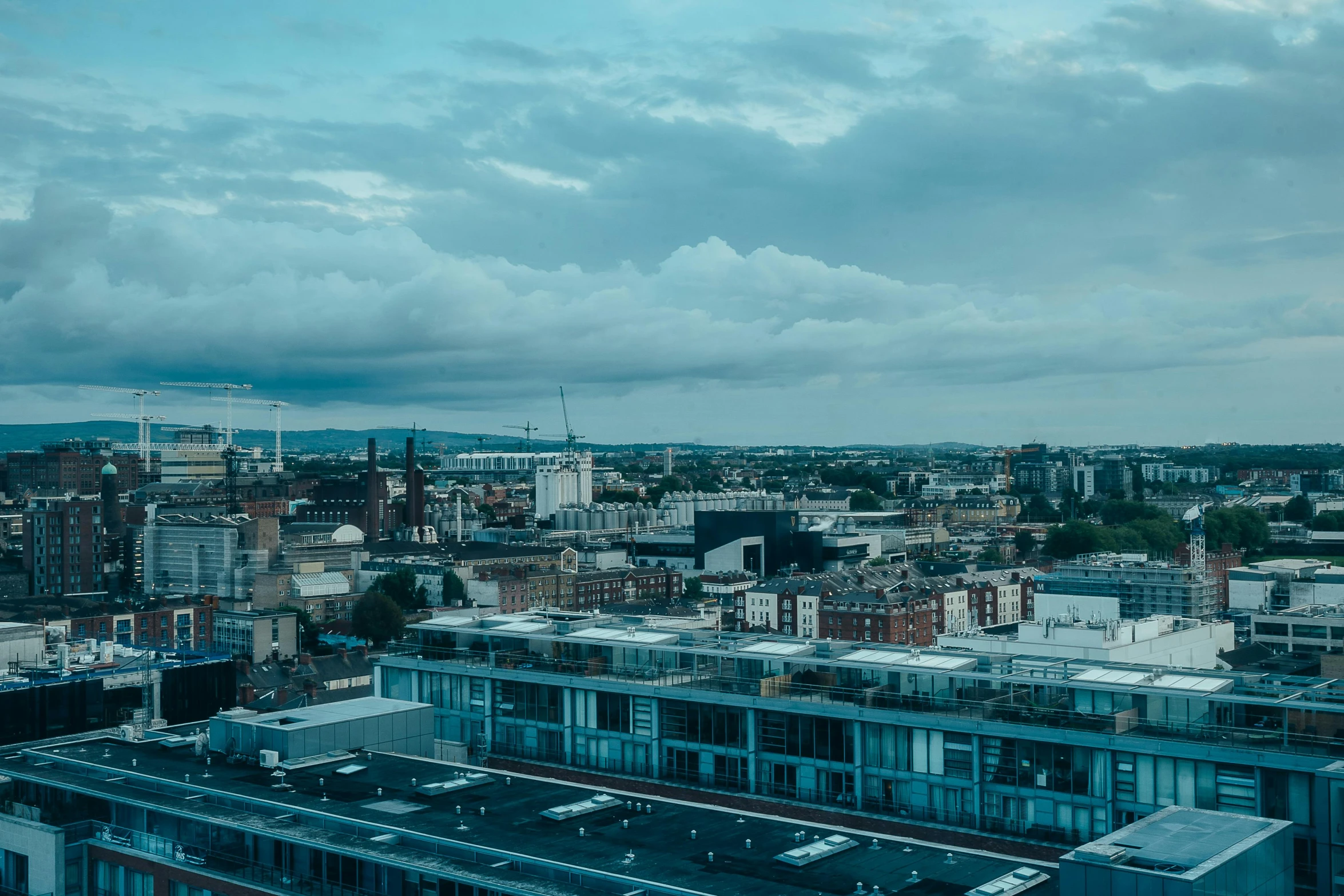 the view of a city with tall buildings in the foreground