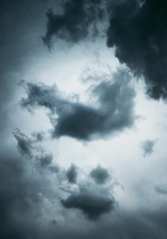 a very dark sky with some white clouds