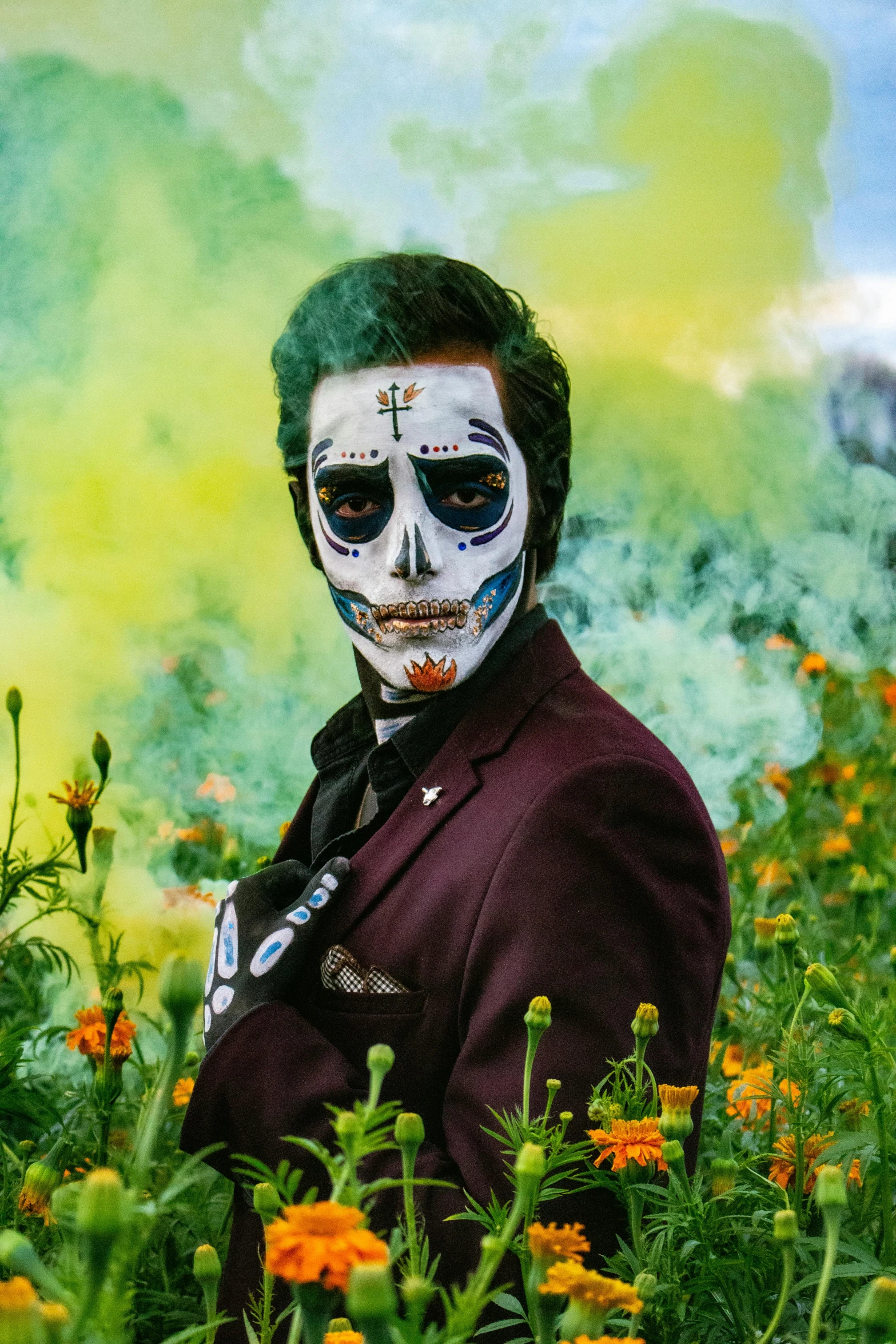 a man in a skull head mask in a flowery meadow