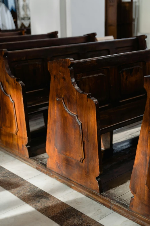 four wooden pews in a row of church pews