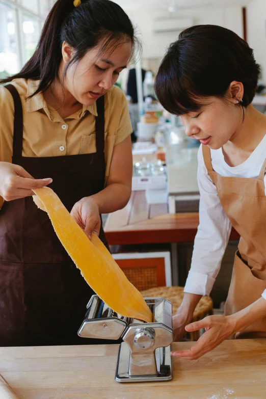 an asian woman and another lady prepare food