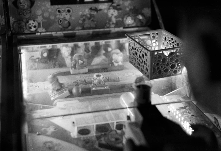 two men looking through the doors of a game machine