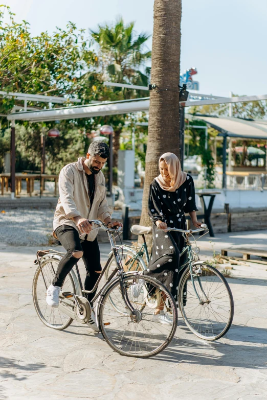 the man and woman are riding their bicycles