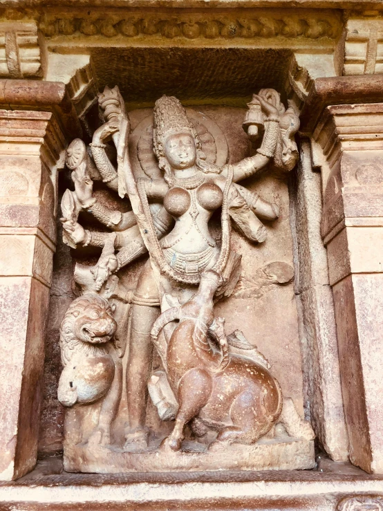 an ancient carved statue on the outside wall of a building