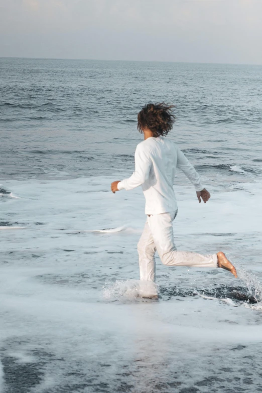 a person is in the water near the beach