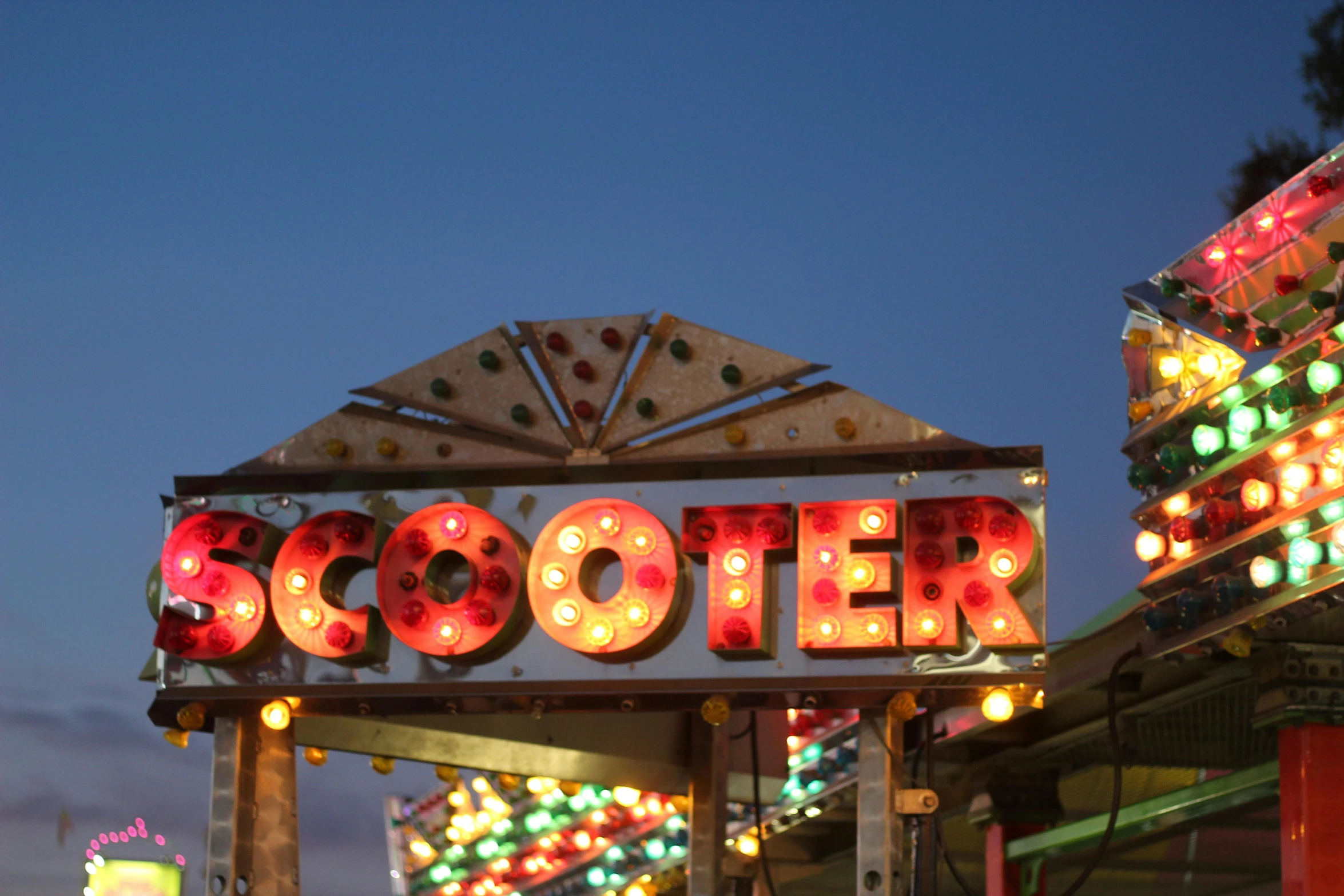 the sign that says socooter at night time