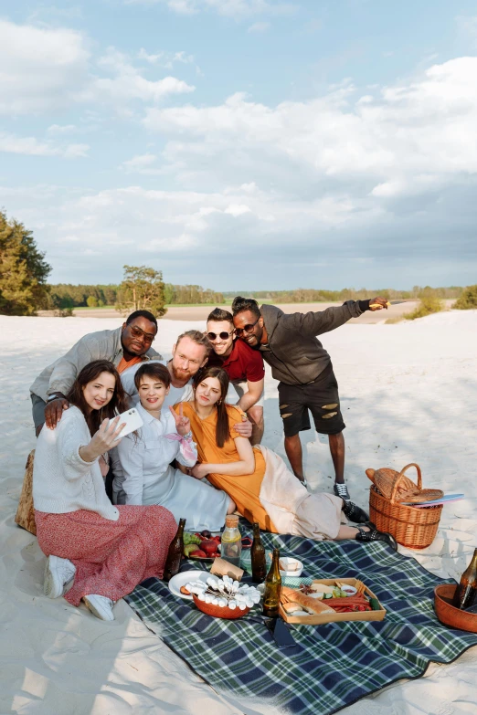 the group of friends is enjoying their picnic