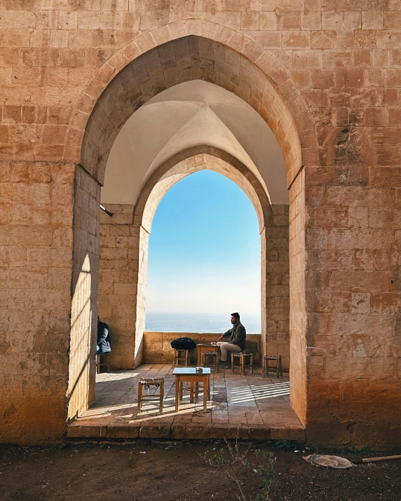 a view through an arched doorway into an ocean view