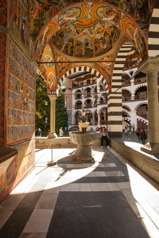 a long hallway with a fountain in the middle