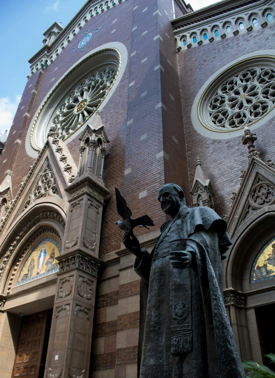 a statue of a person in front of an old church