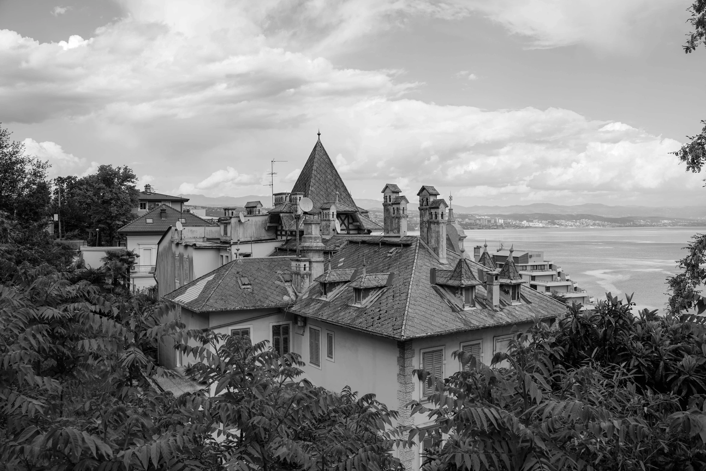 the architecture of a mansion on a cliff overlooks the ocean