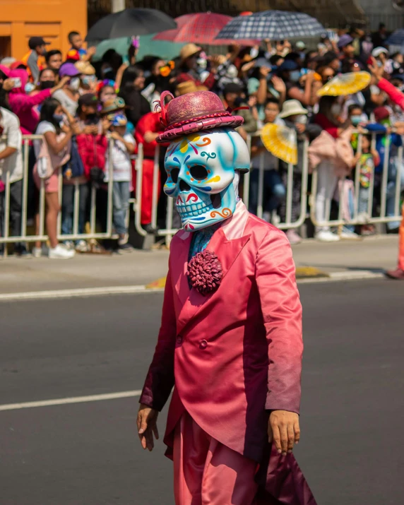 a man in a skeleton mask and pink outfit