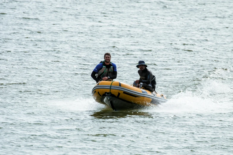 two men on a raft going down the water